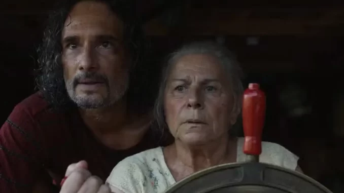 o-ultimo-azul-rodrigo-santoro-denise-weinberg_copiar Cena do filme 'O Último Azul' mostrando um homem de cabelo encaracolado e uma mulher idosa olhando com expressões de preocupação em um cenário de cinema.