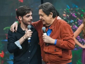 Filho de Faustão falando sobre recuperação, cautela e fisioterapia em evento com o apresentador e uma dançarina no fundo