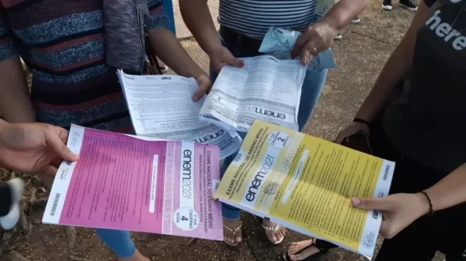 abstencao-enem2025-27percentima-media-nacional Estudantes discutindo informações sobre o Enem 2021, destacando a abstenção de 27% na prova, que mantém a média anual nacional, em um cenário de alta participação.