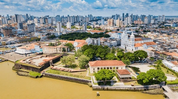 Vista aérea de Belém mostrando a cidade com destaque para a área histórica e o rio, destacando como o evento COP30 eleva o turismo brasileiro e projeta Belém no cenário global.