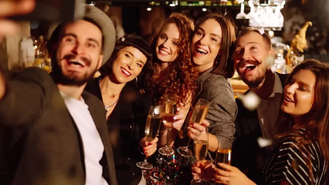 festa-fim-ano-empresa-postura-profissional Funcionários celebrando na festa de fim de ano da empresa, demonstrando alegria e camaradagem, ao mesmo tempo que mantêm postura profissional e evitam exageros.